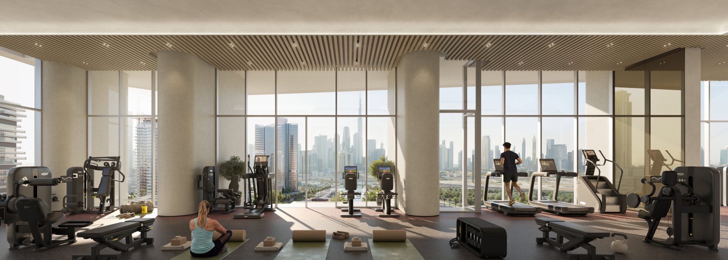 Fully equipped gymnasium with floor-to-ceiling glazing framing the Downtown skyline