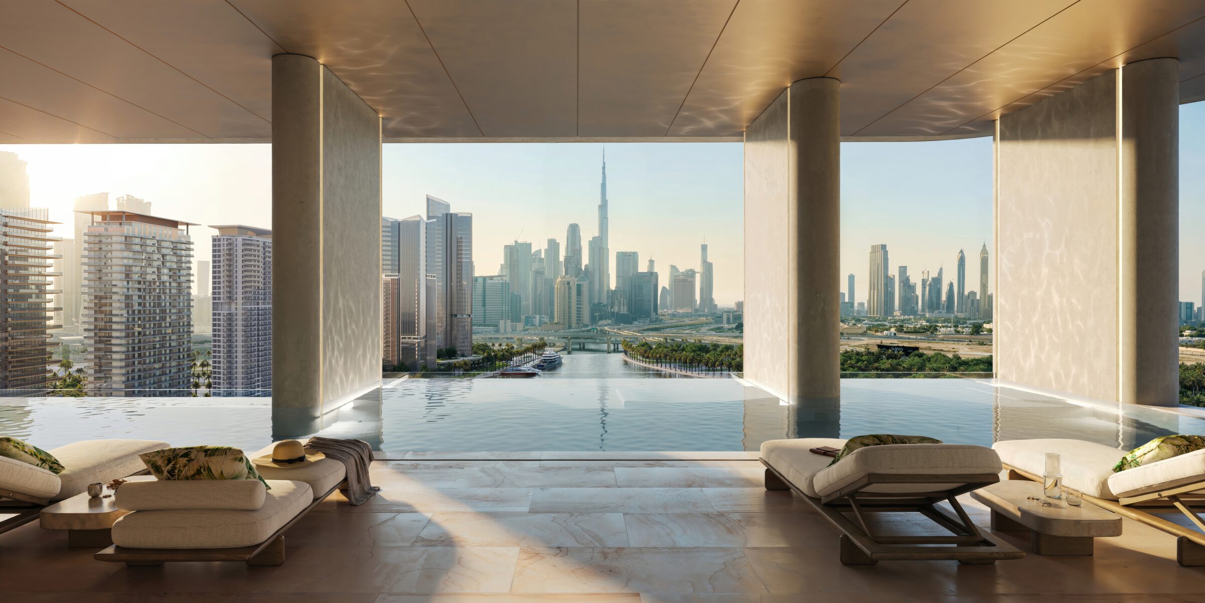 Sky-level infinity pool at sunset with loungers and cabanas, the Burj Khalifa on the horizon
