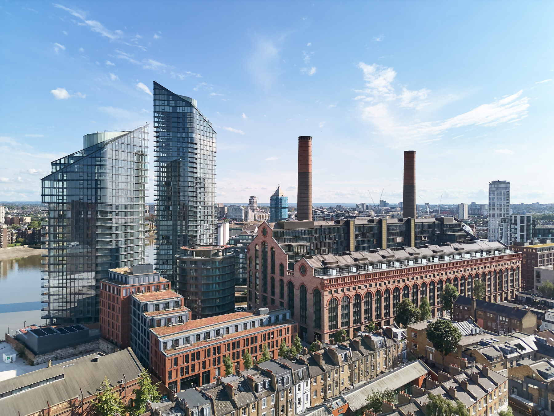Aerial view of the full estate: towers, restored power station, creek and gardens
