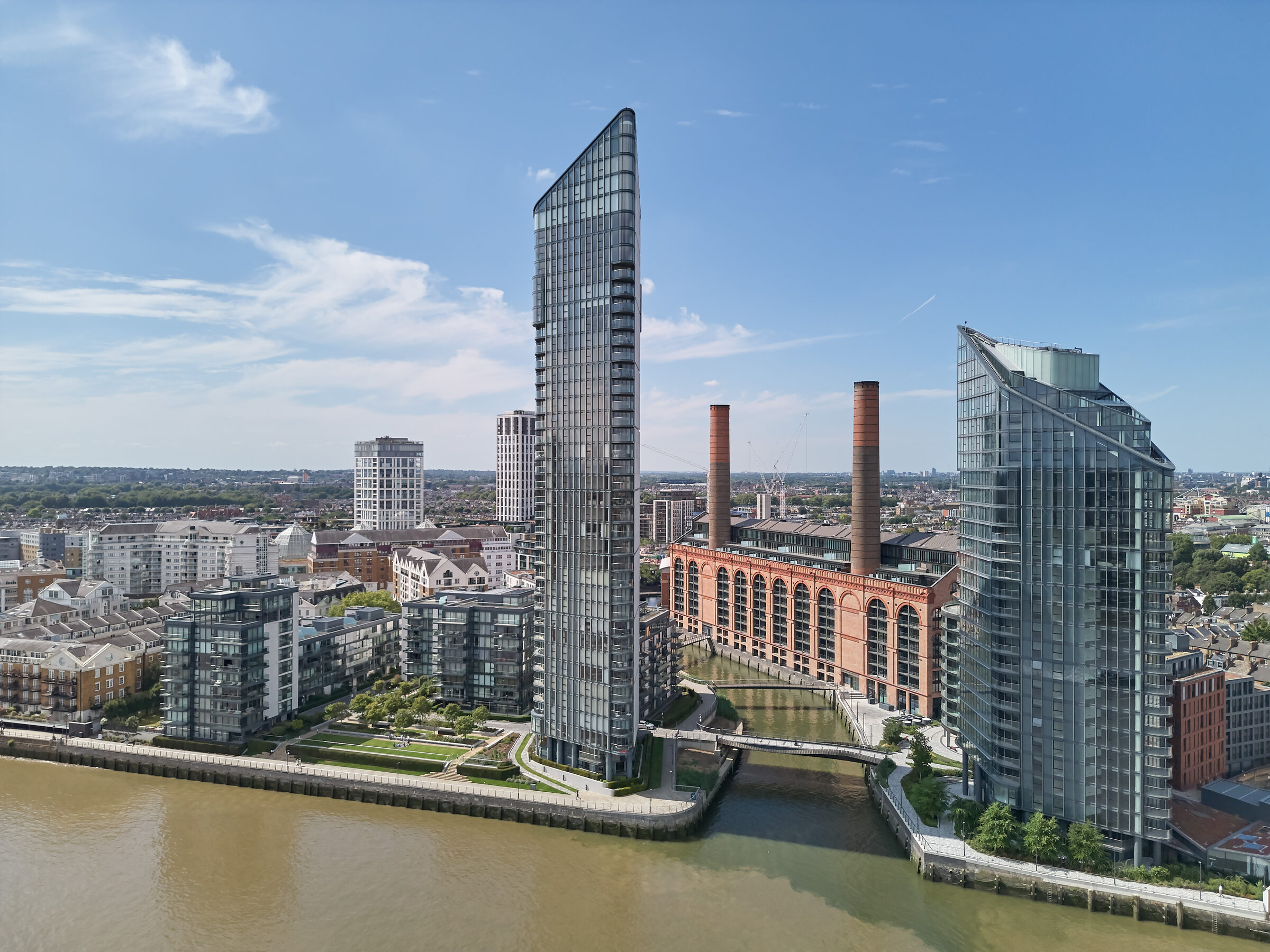 The estate from above the Thames: two glass towers flanking the restored power station and its chimneys