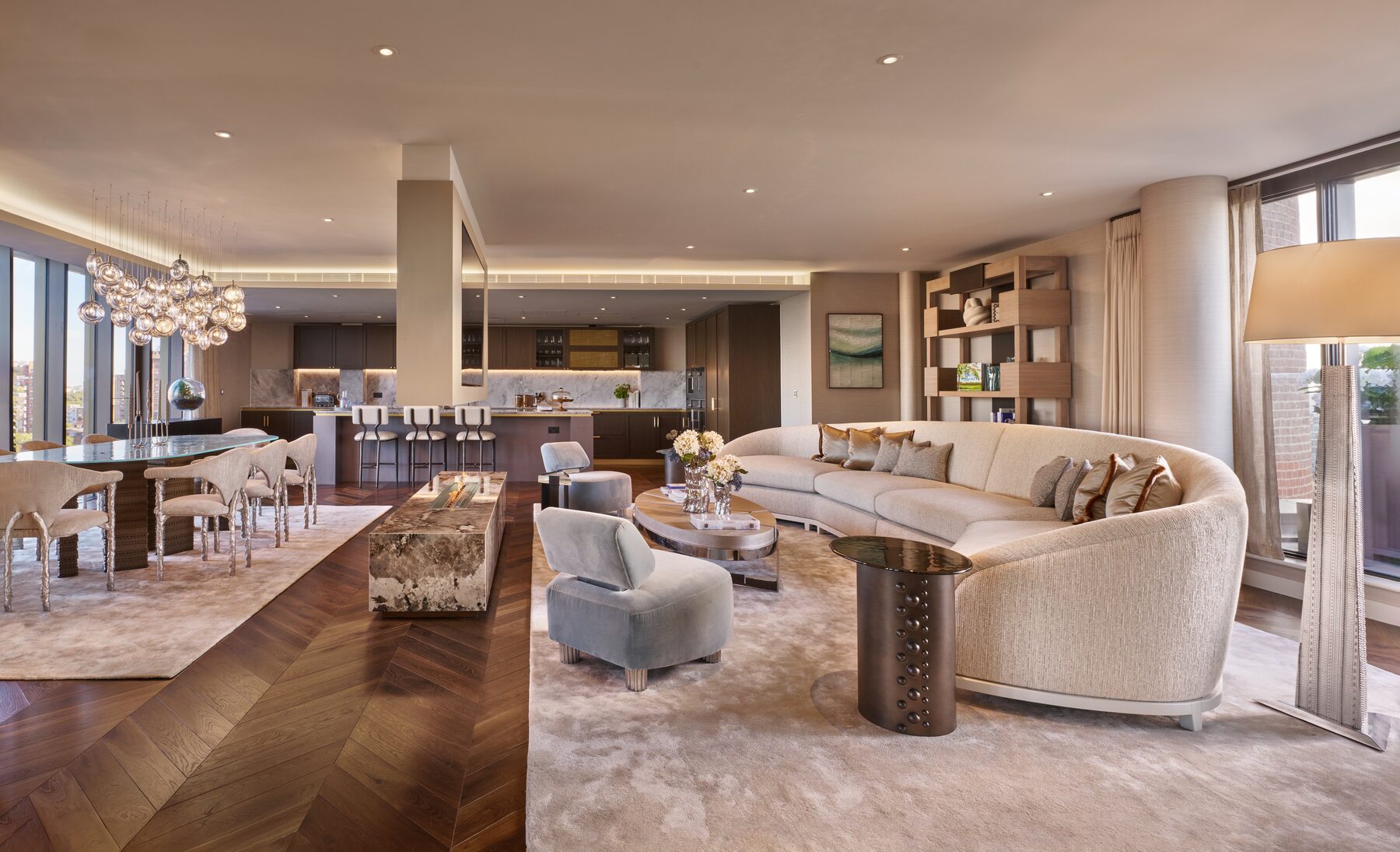 Penthouse living space with chevron oak floors, marble fireplace and open kitchen
