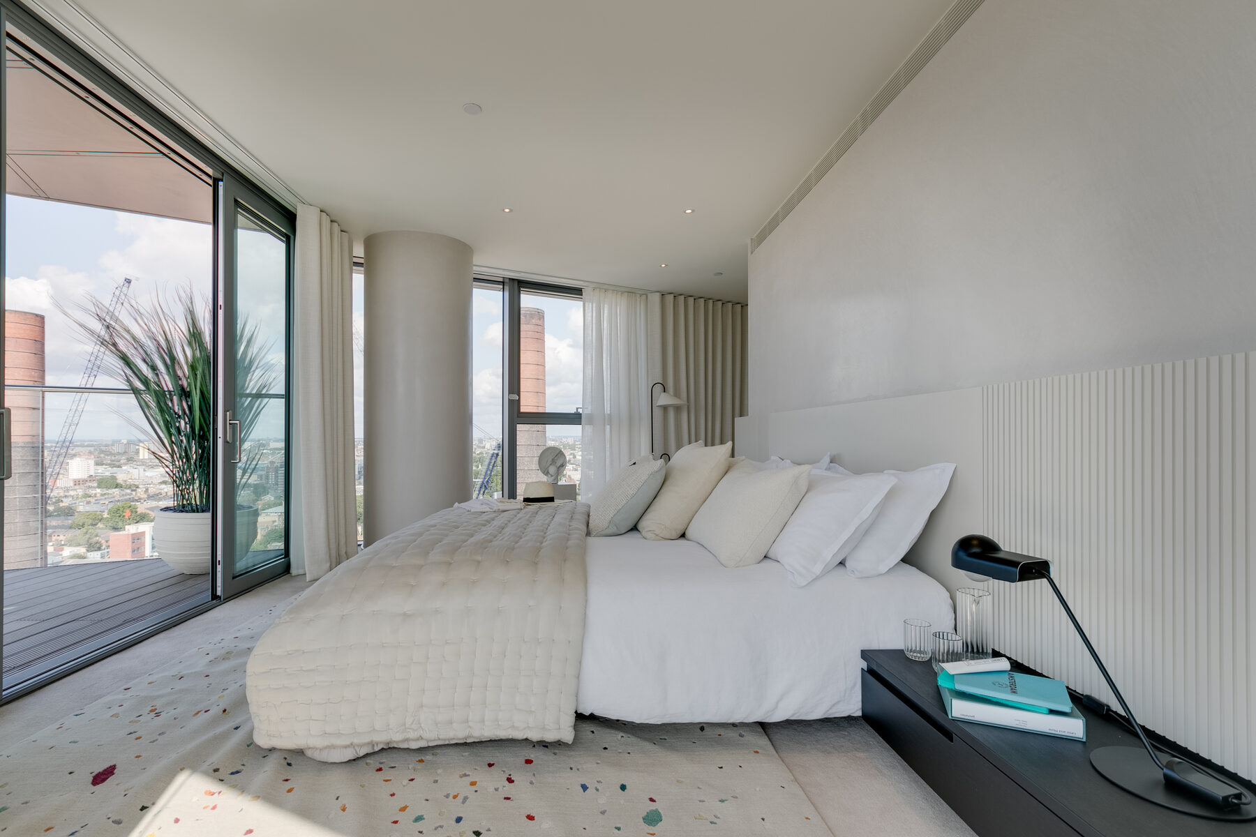 Principal bedroom opening to a terrace beside the retained brick chimney