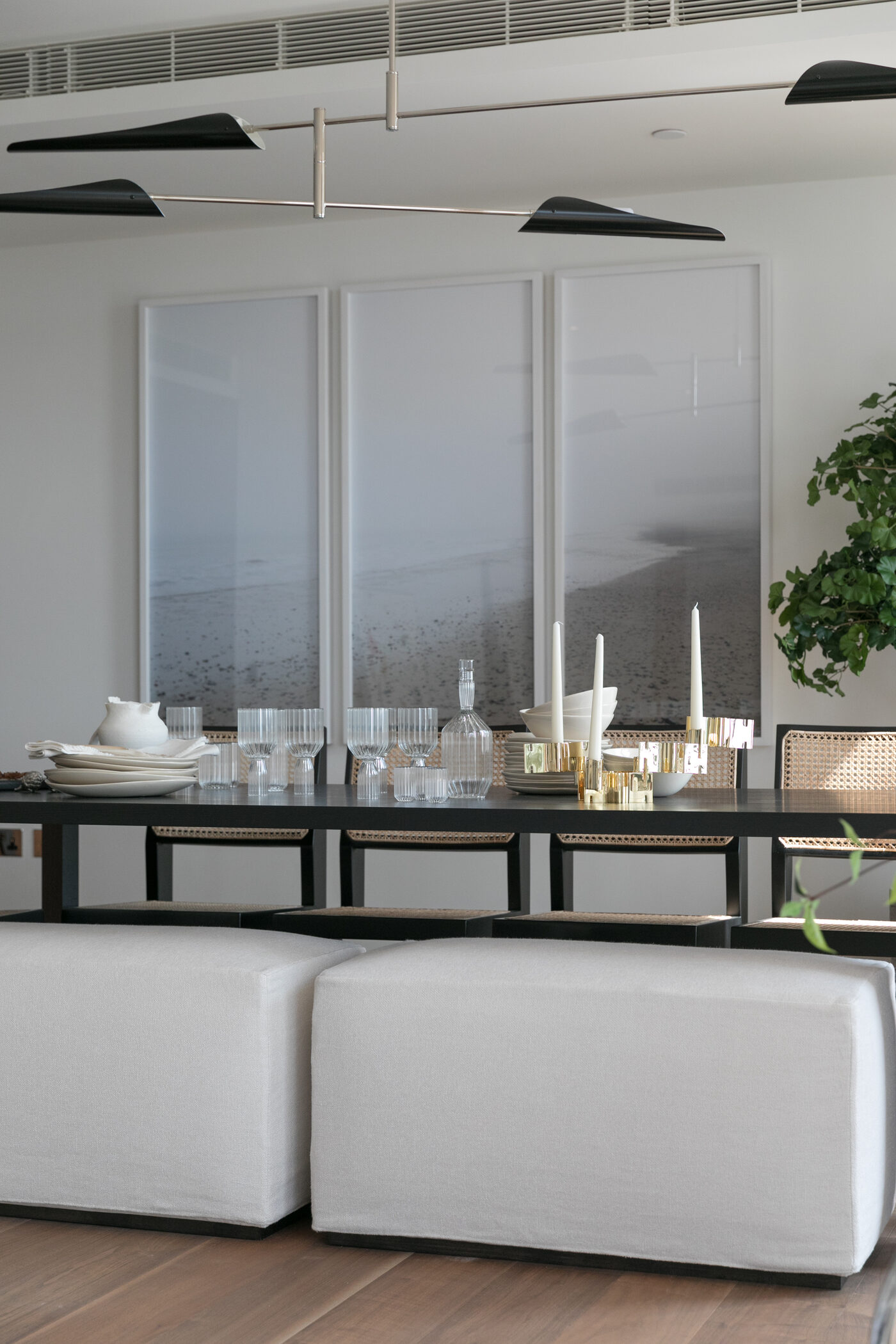 Dining room detail with cane chairs and layered glassware