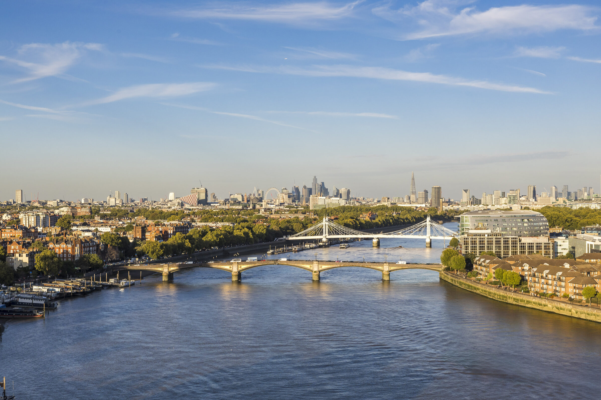 The view east along the Thames over Battersea and Albert Bridges towards the City skyline