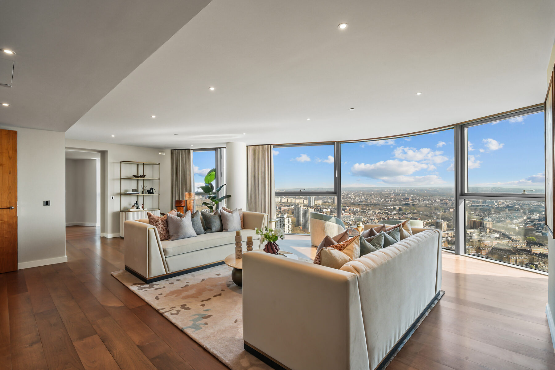 Curved reception room with panoramic glazing over west London
